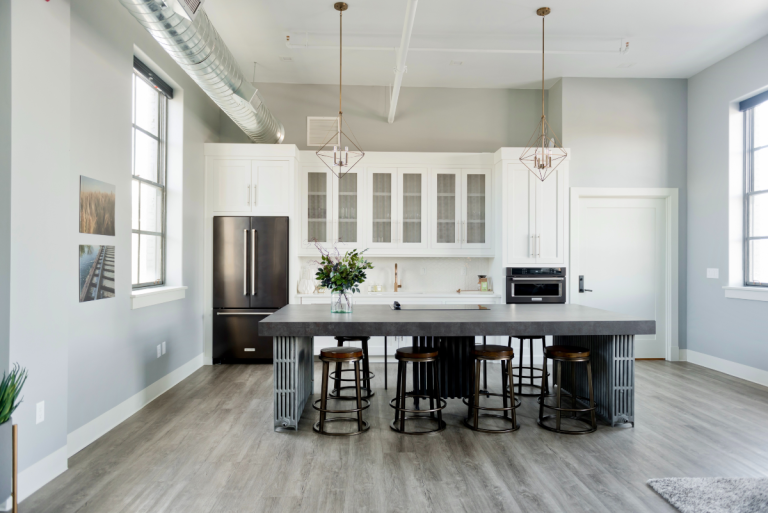 clean-bright-kitchen-with-stone-countertop-and-barstools