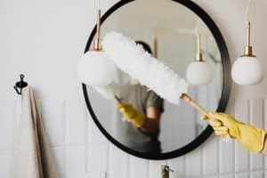 Professional house cleaner from Merit Maids sanitizing a bright modern kitchen in Arvada, CO, showcasing recurring cleaning services in action.