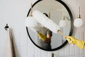 Professional house cleaner from Merit Maids sanitizing a bright modern kitchen in Arvada, CO, showcasing recurring cleaning services in action.